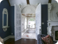Two white doors open into a room with chairs and a window.