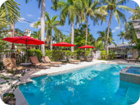 Lounge chairs surrounding an outdoor pool.