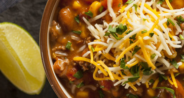 Southwestern Santa Fe soup with cheese on top.