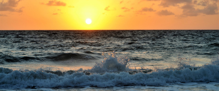 Sunset and waves crashing on the shore of Lake Michigan