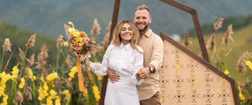 Elopement couple with fresh-picked flowers