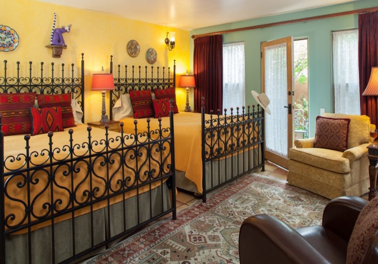 four kachinas bedroom two beds with iron posts bright colors unique artwork 
